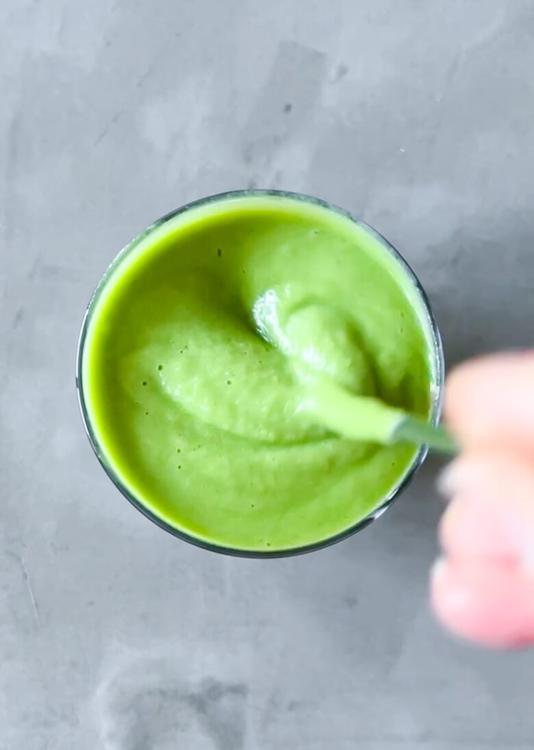 Daily harvest pineapple matcha smoothie in a glass.