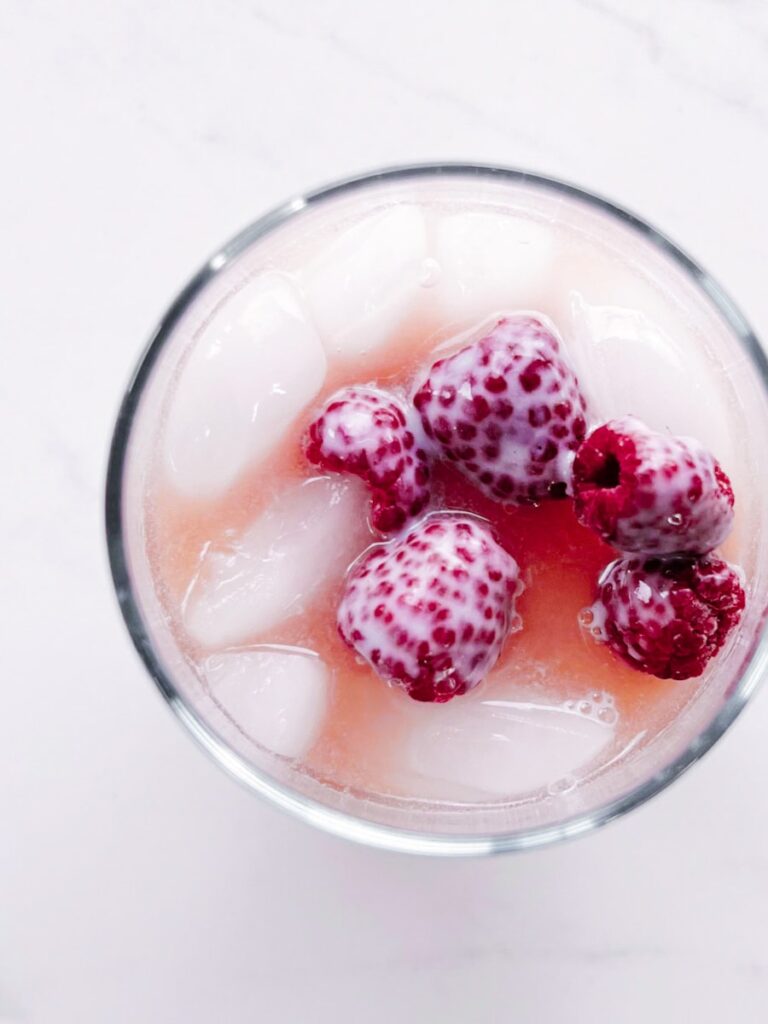 Close up of the copycat pink drink with frozen raspberries
