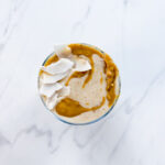 Peanut Butter Banana Date Smoothie with Coconut on top from above.