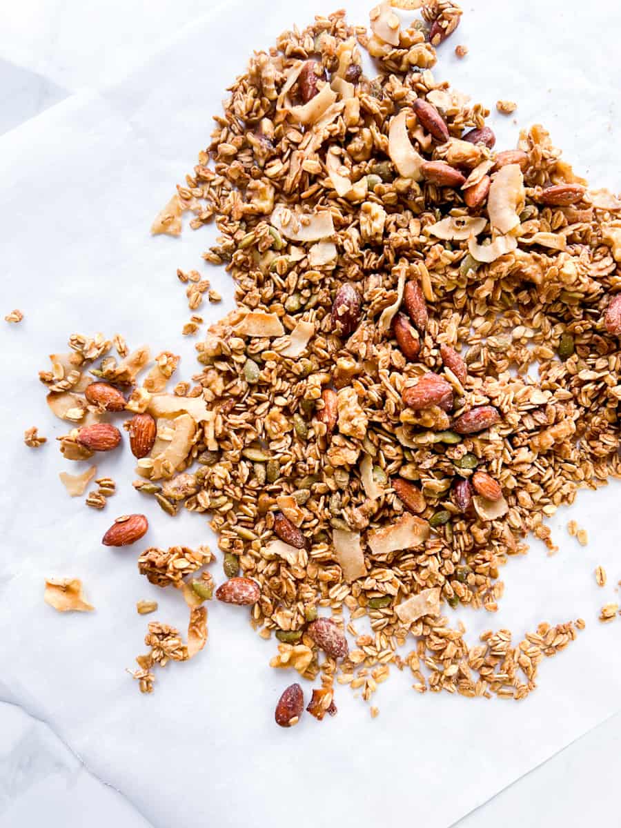 Pan toasted coconut granola on parchment paper.