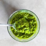 Cashew pesto in a clear glass.