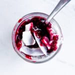 Chia pudding topped with berry compote and coconut flakes