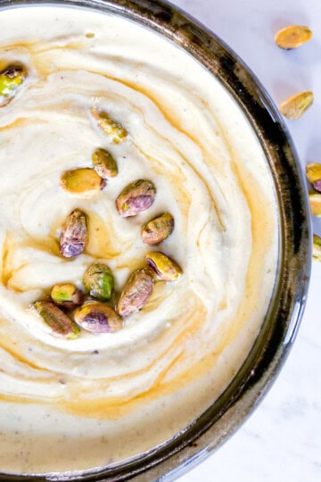 Honey whipped feta in a bowl topped with honey.