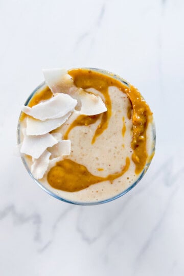 Peanut butter date smoothie topped with coconut.