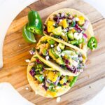 Chicken tacos on a cutting board.