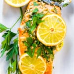Mediterranean Salmon written at the top of a photo with salmon covered in herbs.