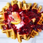 Healthy oat flour waffle on a plate with toppings.