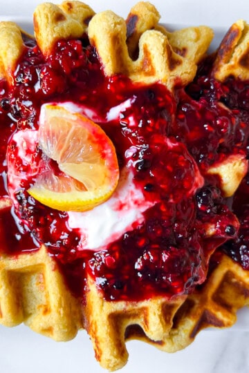 Healthy oat flour waffle on a plate with toppings.