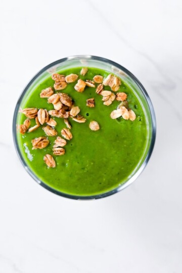 Island green smoothie topped with granola.