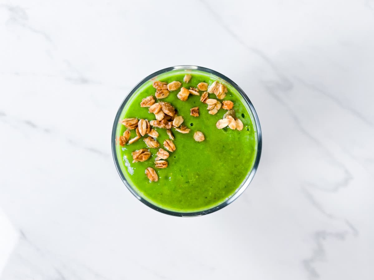 Finished island green tropical smoothie topped with granola.