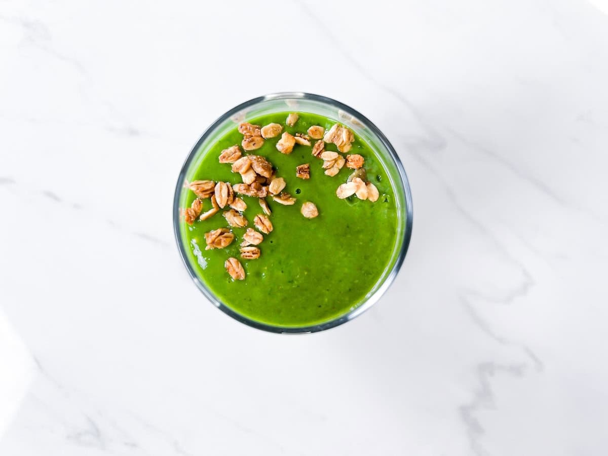 Island green smoothie topped with granola.