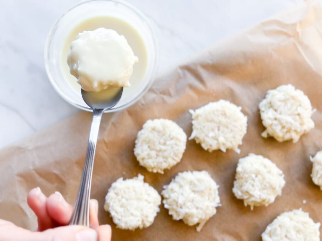 Dipping the Healthy Coconut White Chocolate Balls.