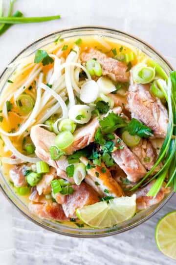 Asian noodle soup in a clear bowl.