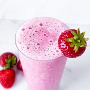 Finished strawberry protein shake in a glass.