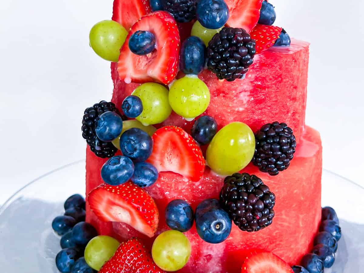 Finished watermelon cake topped with fruit.