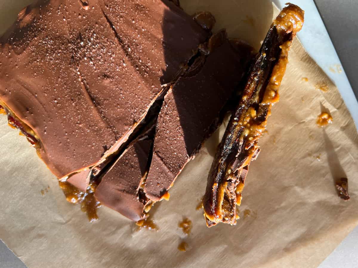 Date bark cut into pieces on parchment paper.