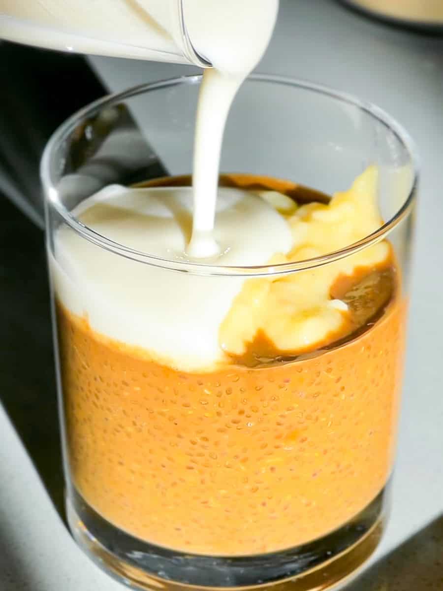 Creamer being poured on chia coffee.