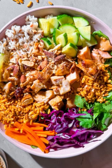 Finished crispy rice bowls with wild rice, chicken, veggies, and cashew dressing.