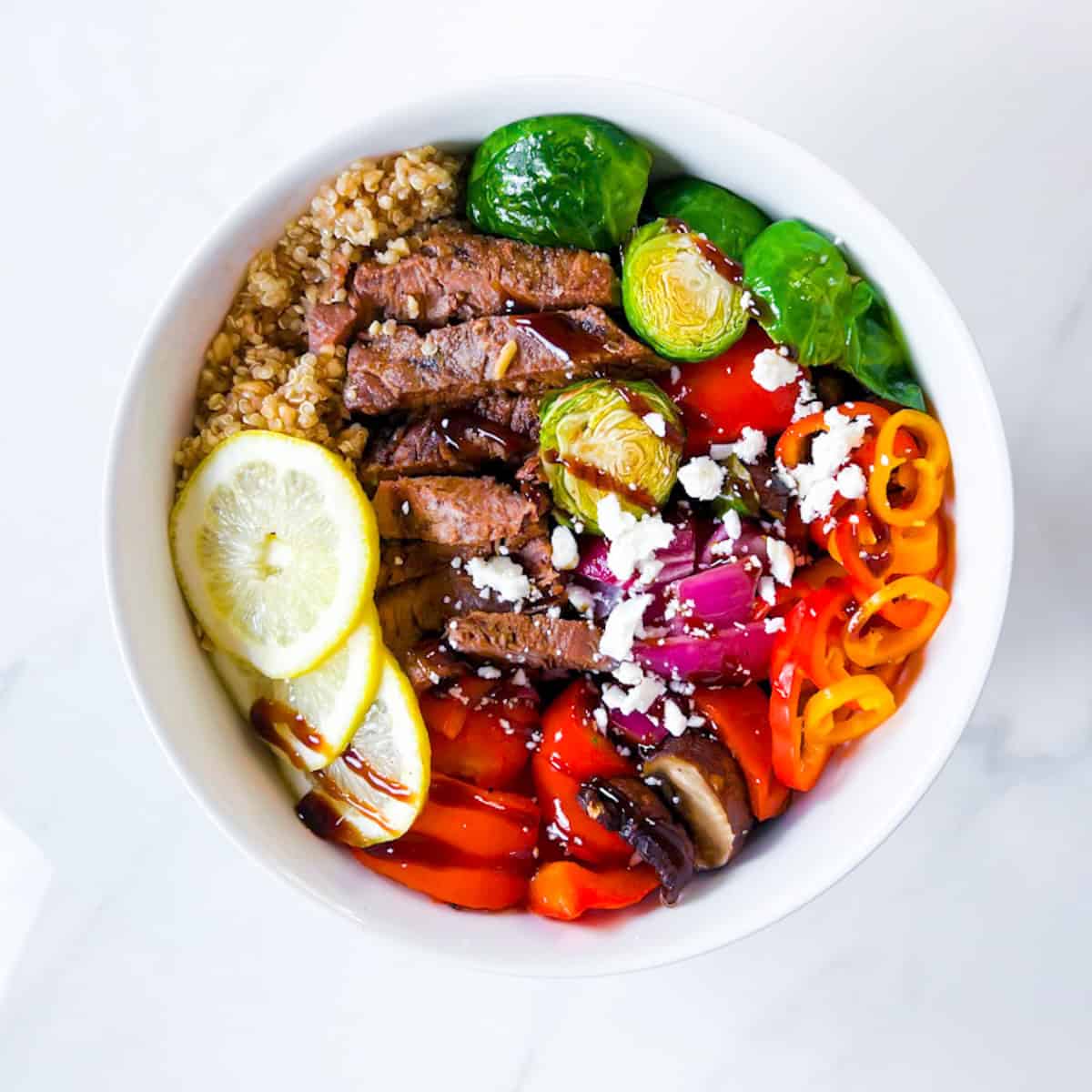 Steak grain bowls with quinoa, and roasted vegetables.