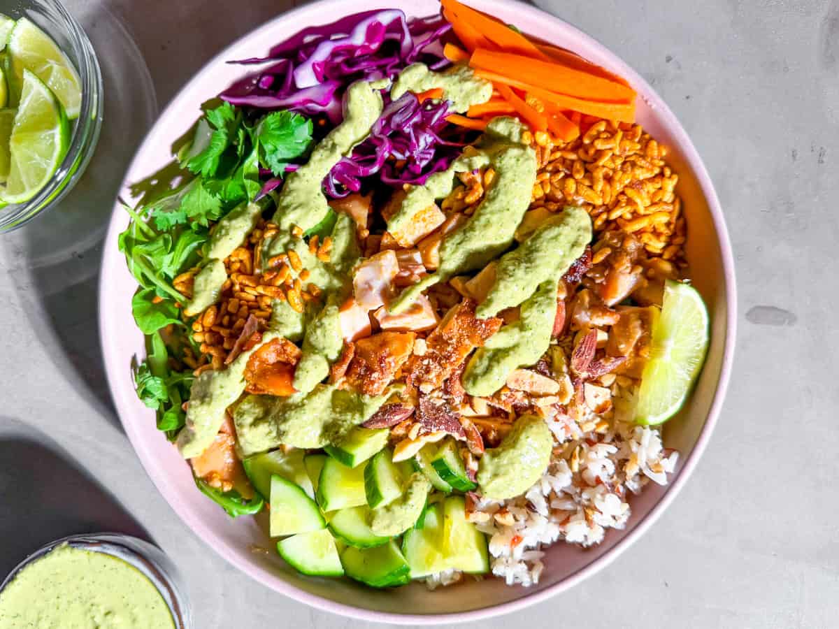 Finished Sweetgreen crispy rice bowl with spicy cashew dressing drizzled on top.