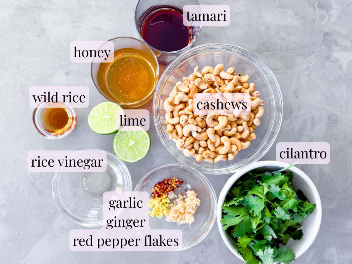 Ingredient photo of the spicy cashew dressing ingredients in clear bowls and labeled.