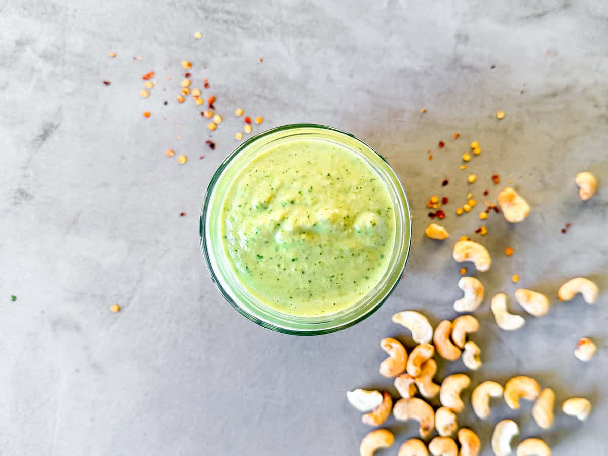 Overhead of finished spicy cashew dressing in a jar.