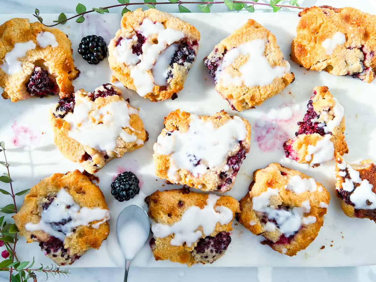 Baked blackberry scones drizzled with a glaze.