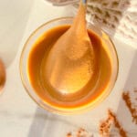 Blended cinnamon peanut butter with a spoon in it.