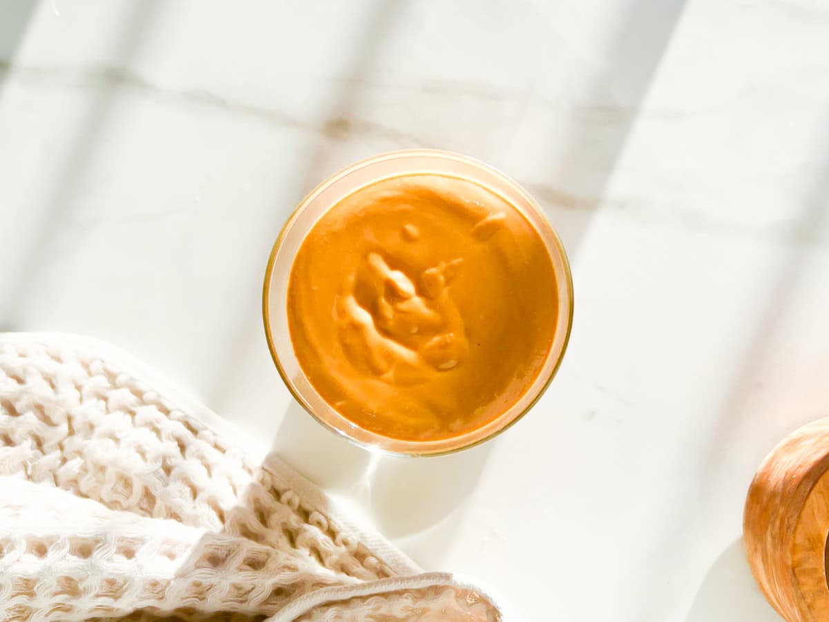 Fully blended cinnamon peanut butter in a glass jar.