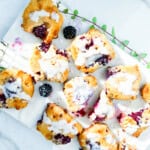 Baked blackberry scones drizzled with a glaze.