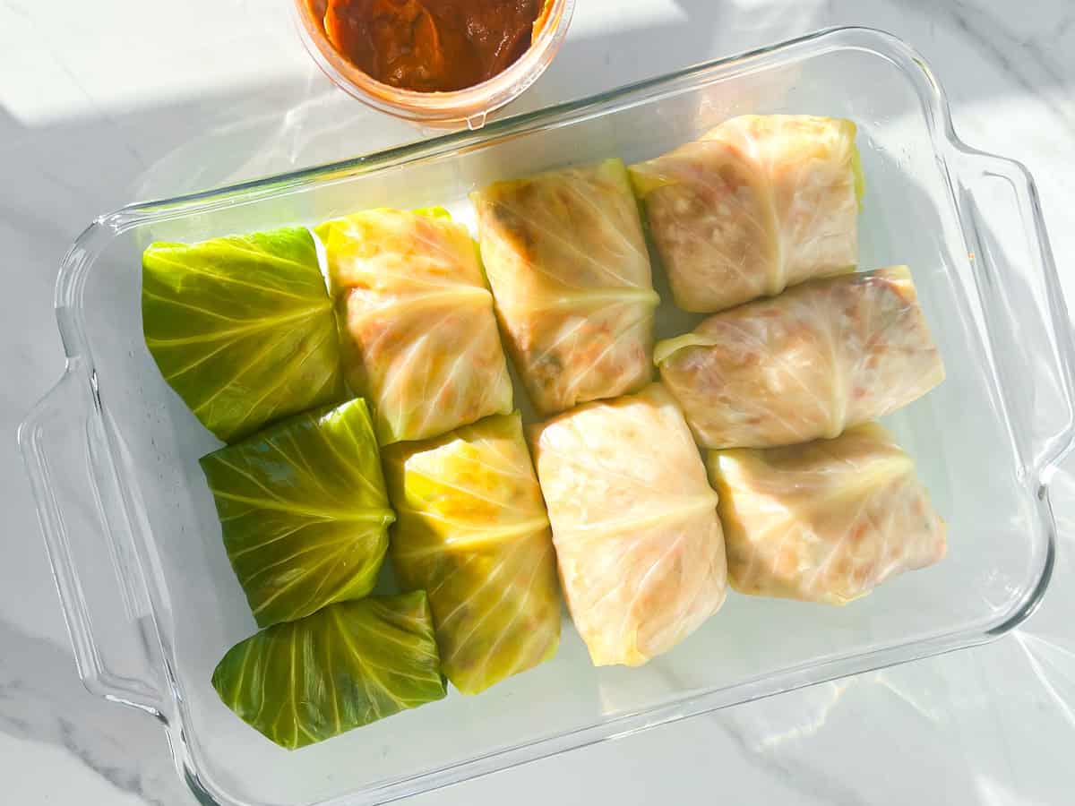 Lebanese cabbage rolls rolled an set in a baking dish.