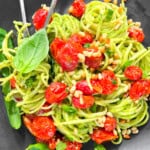 Pasta al Pesto on a black plate.