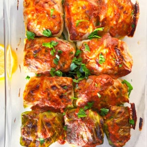 Finished malfouf cabbage rolls in a clear dish.