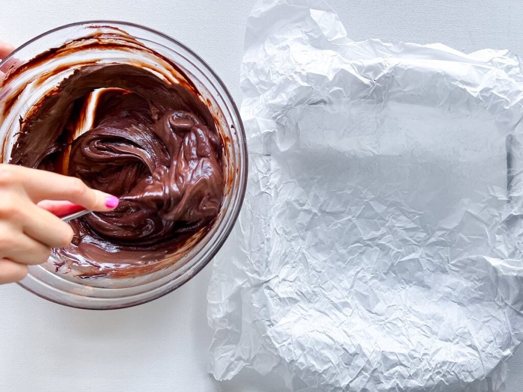 Brownie batter and parchment pan.