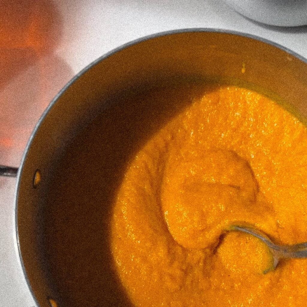 Carrot & squash soup in a pot.