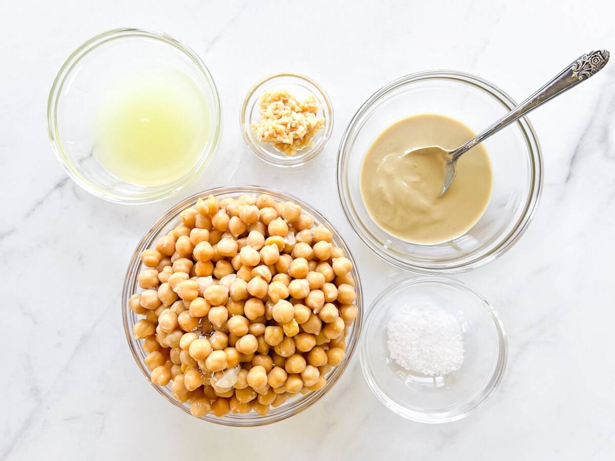 al of the hummus ingredients in small bowls.