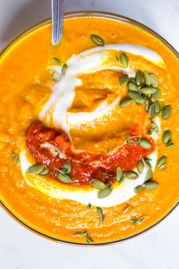 Finished butternut squash and carrot soup in a bowl.