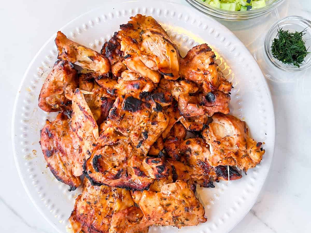 Cava grilled chicken on a white plate.