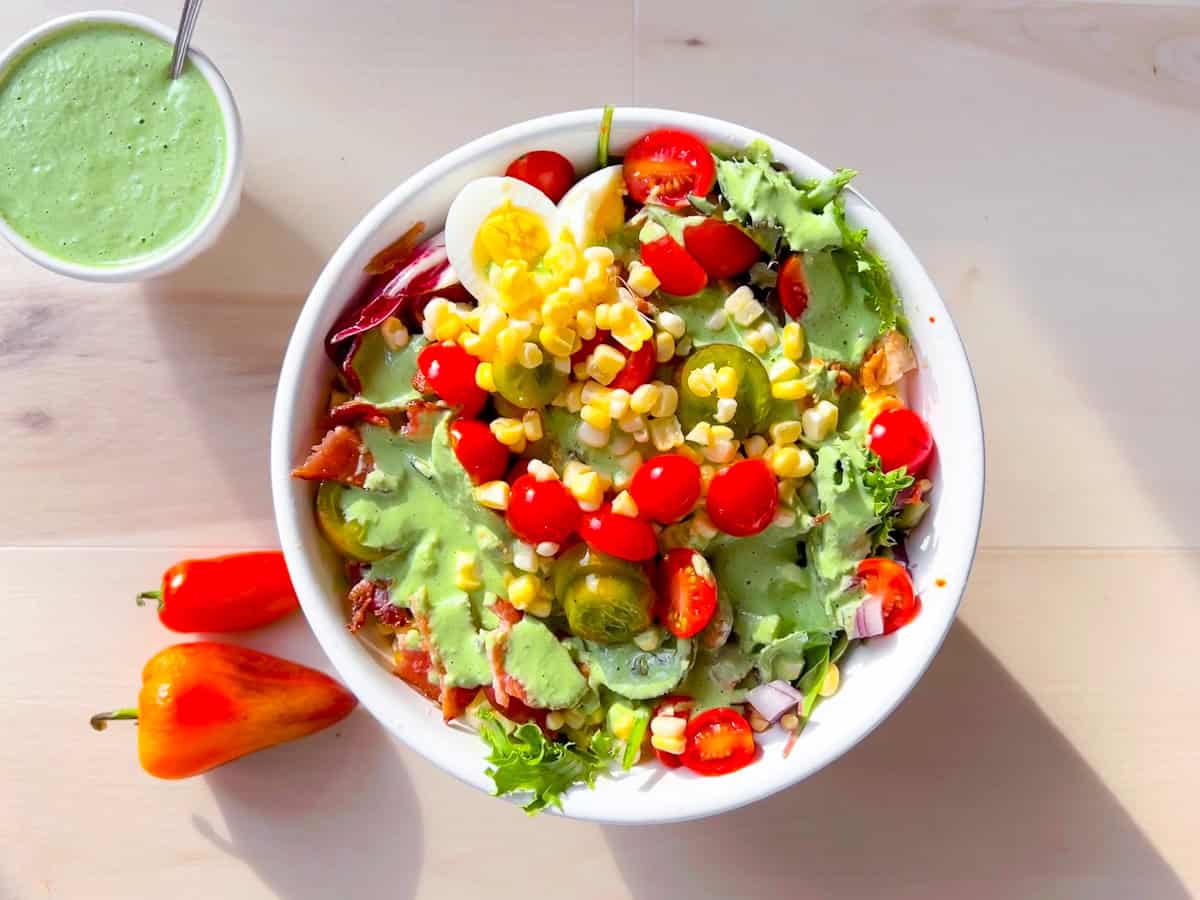 Finished Chick-Fil-A Cobb Salad with avocado lime ranch drizzled on top.