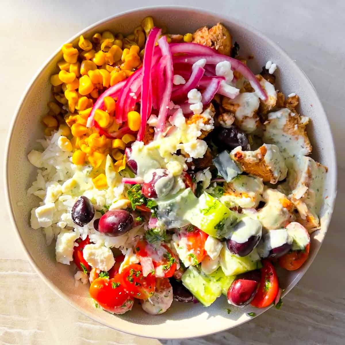 Cava bowl filled with mediterranean ingredients in a white bowl.