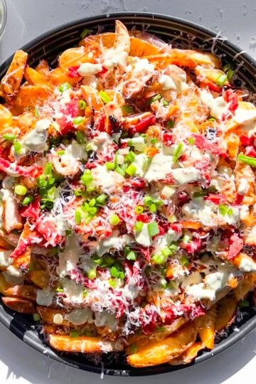 Finished loaded fries on a big platter.