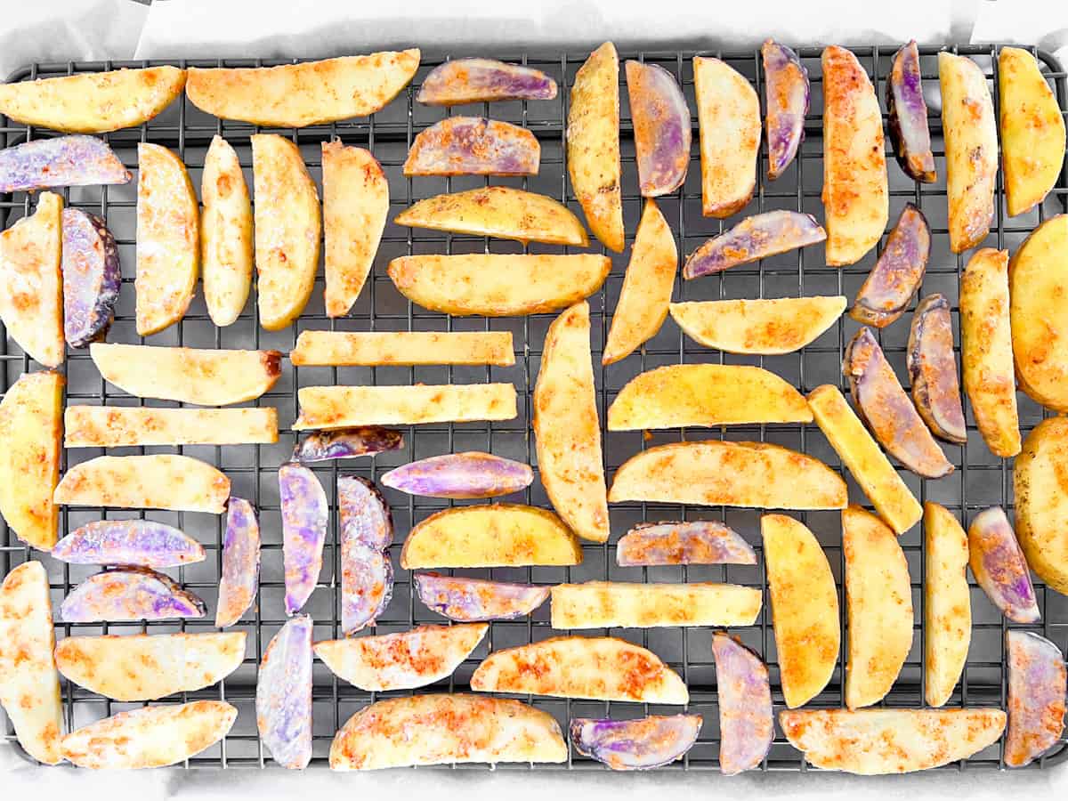 Fries on baking sheet spread evenly.