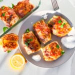 Lebanese cabbage rolls on a plate with greek yogurt.