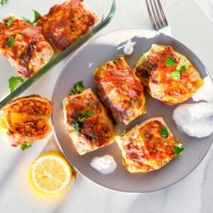Lebanese cabbage rolls on a plate with greek yogurt.