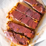 Dates covered in peanut butter and chocolate parchment paper.