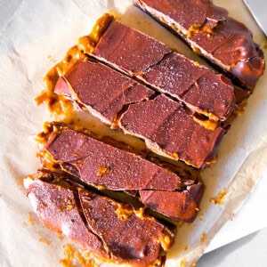 Dates covered in peanut butter and chocolate parchment paper.