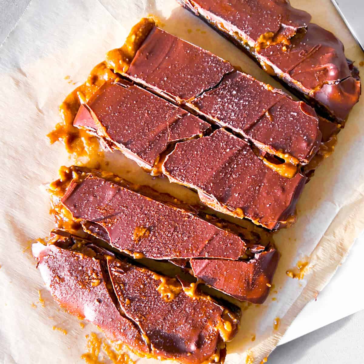 Dates covered in peanut butter and chocolate parchment paper.