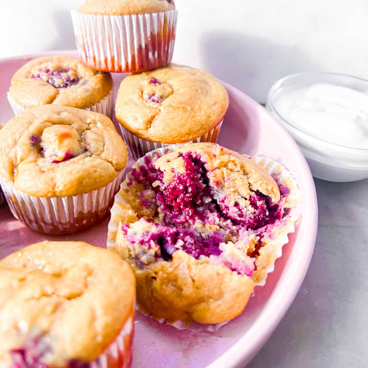 Banana Blackberry Oatmeal Muffins on a pink plate.