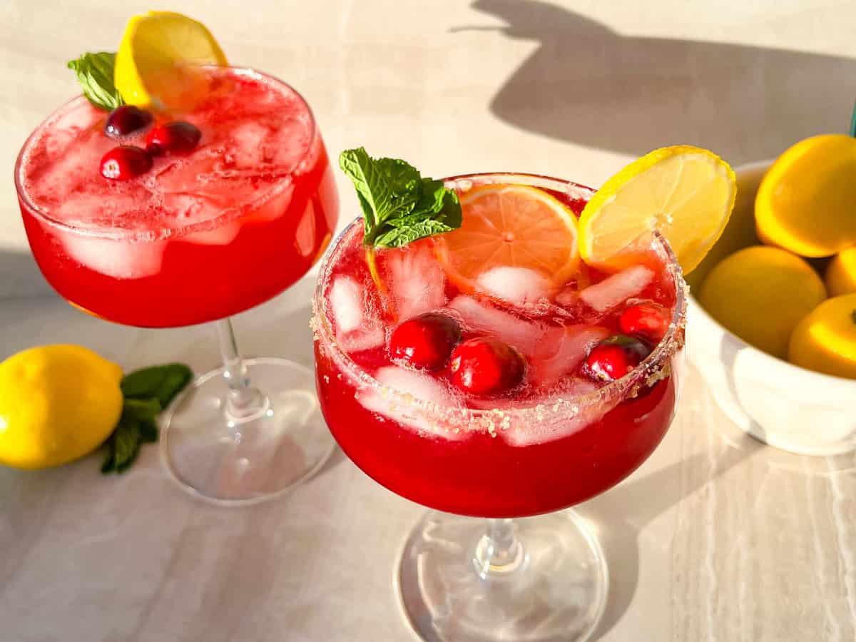 Finished and garnished cranberry ginger beer mocktails in a glass.