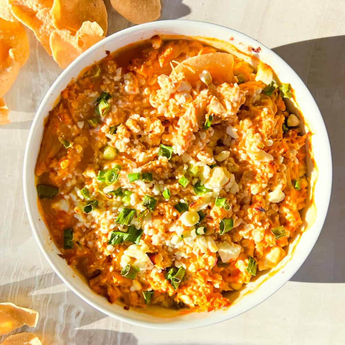 High Protein Buffalo Chicken dip with chips around it.